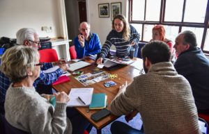 Photograph of a group of people discussing together in a meeting