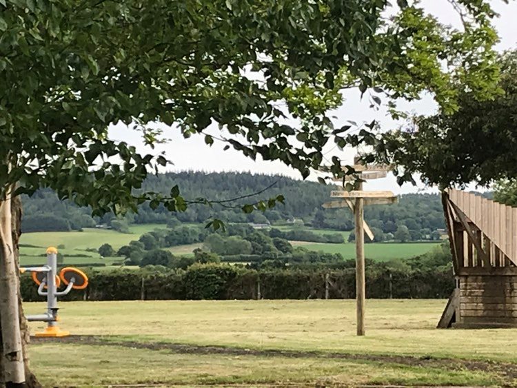 Photograph of a school playground surrounded by the countryside.