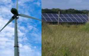 Photograph of a wind turbine and solar panels in a field