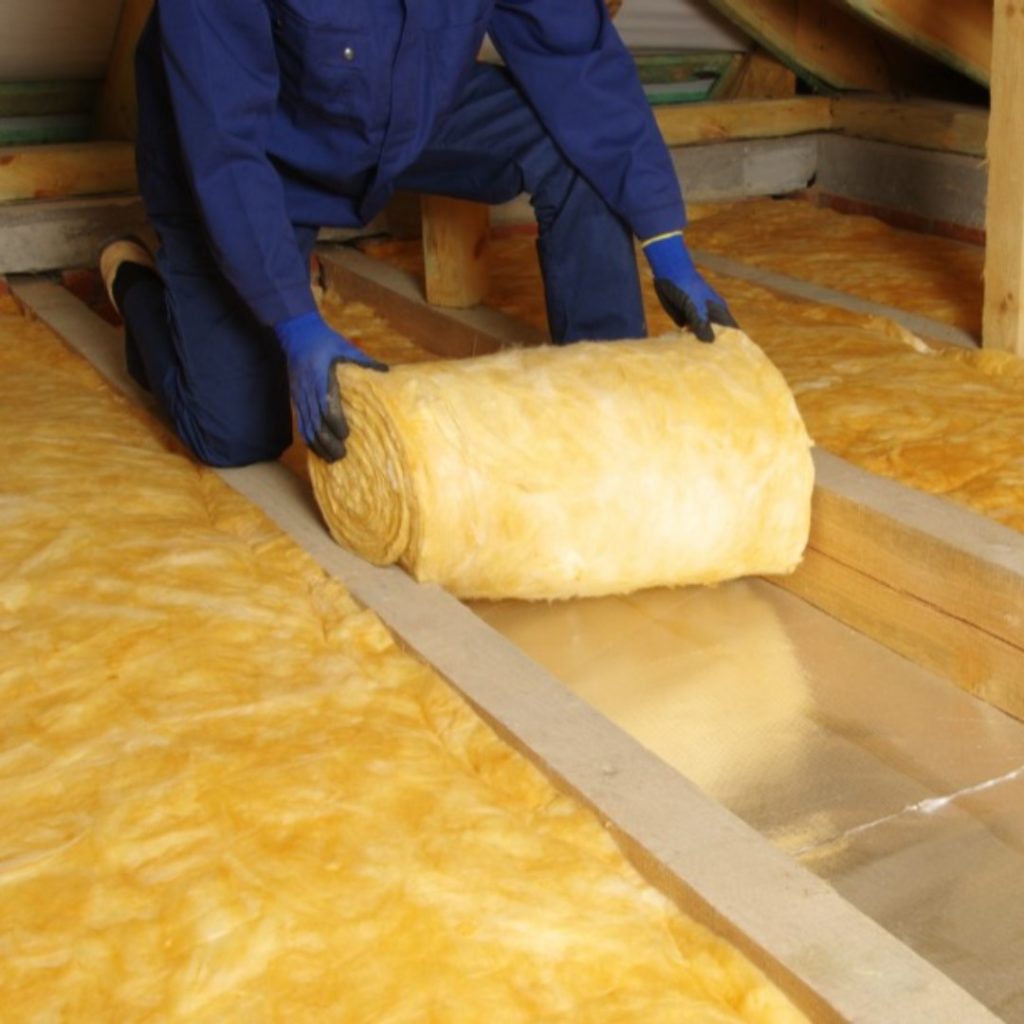 Photograph of a person installing loft insulation