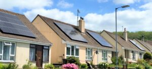 photograph of houses fitted with solar panels on their roofs