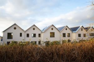 Photograph of houses with solar panels on roofs